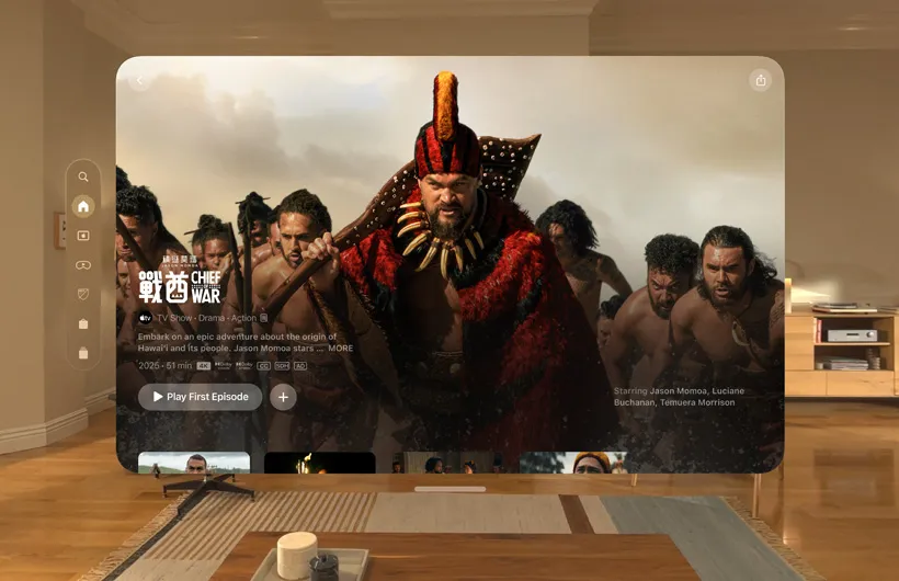 The Apple TV experience of Apple Vision Pro is displayed in a living room, with a still image from the Apple TV series Chief of War