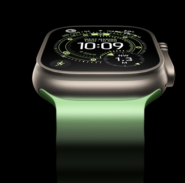 A close-up of a Natural Titanium Apple Watch Ultra 3 on a black background. The display shows the time and other dynamic info.