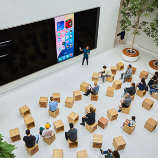 Birds-eye view of a business training session at an Apple Store.