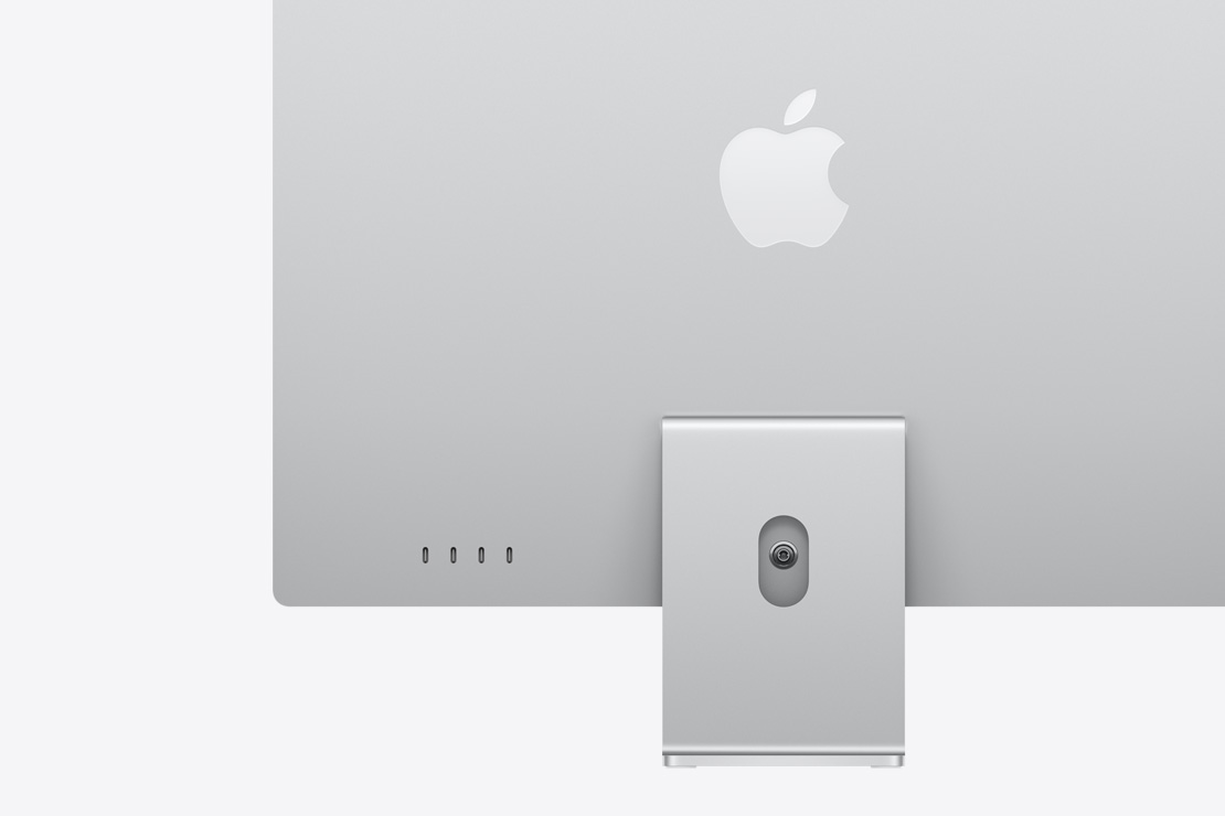 Skats no aizmugures uz sudraba krāsas iMac, izcelti četri USB‑C porti