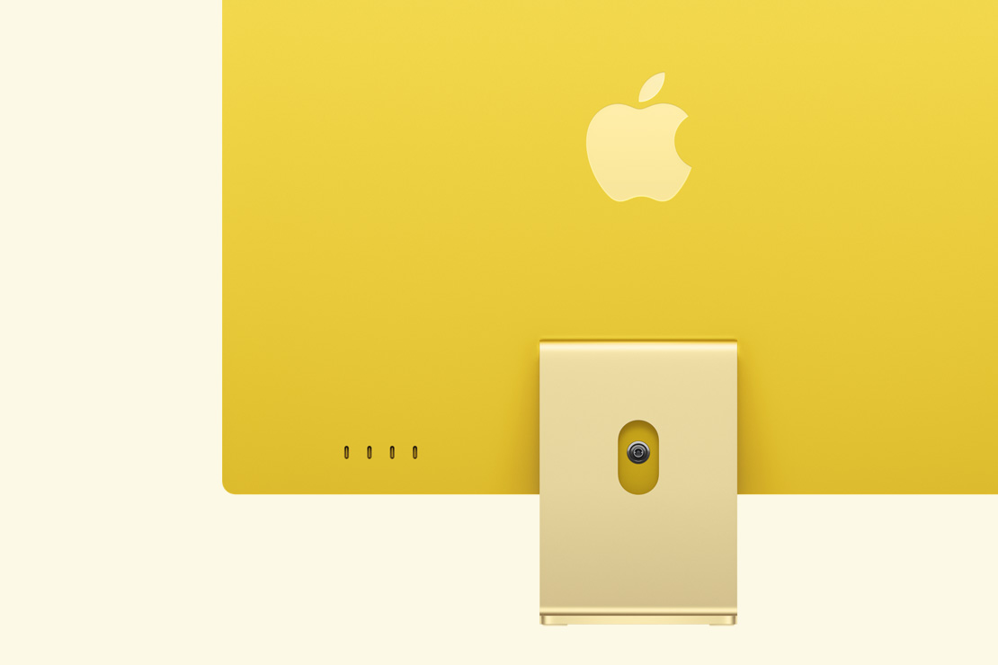 Skats no aizmugures uz dzeltenu iMac, izcelti četri USB‑C porti