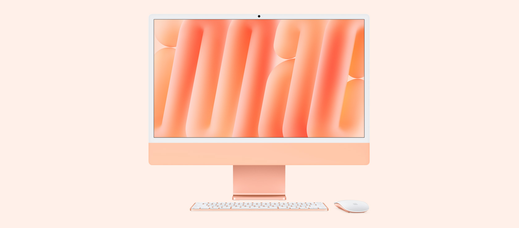 Skats no priekšpuses uz oranžu iMac ar pieskaņotas krāsas peli un tastatūru