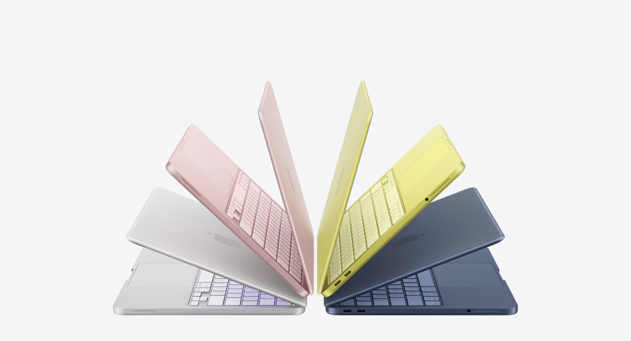 銀色、胭脂色、橘黃色、靛藍色 MacBook Neo 手提電腦，微微打開，以拱形排列